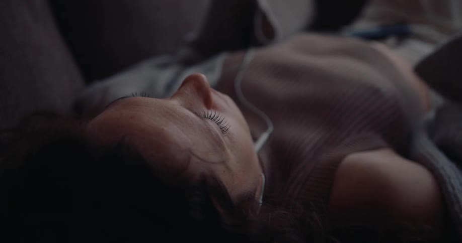 A clip of a lady listening to music
