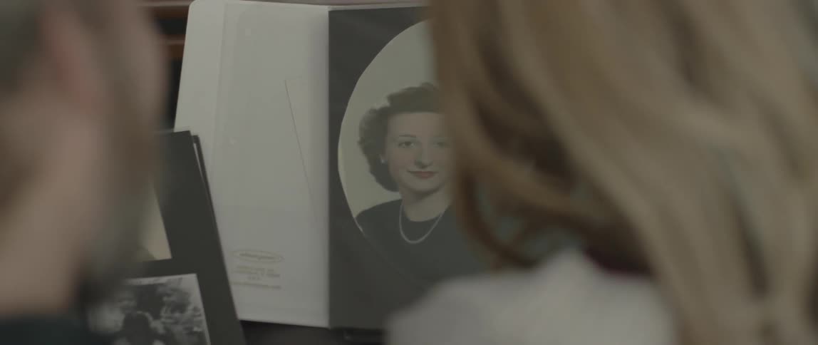 A man and woman look at a photo album