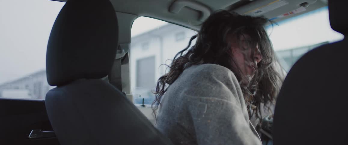 Male headbanger sits in the driver seat while enjoying music