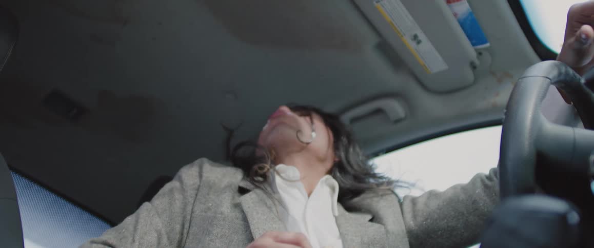 A footage of an overjoyed person eating in a car