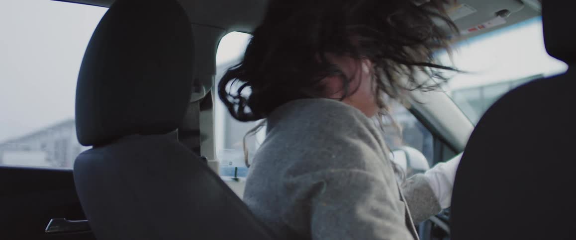 Man enjoying music in his car head bangs and punches the air