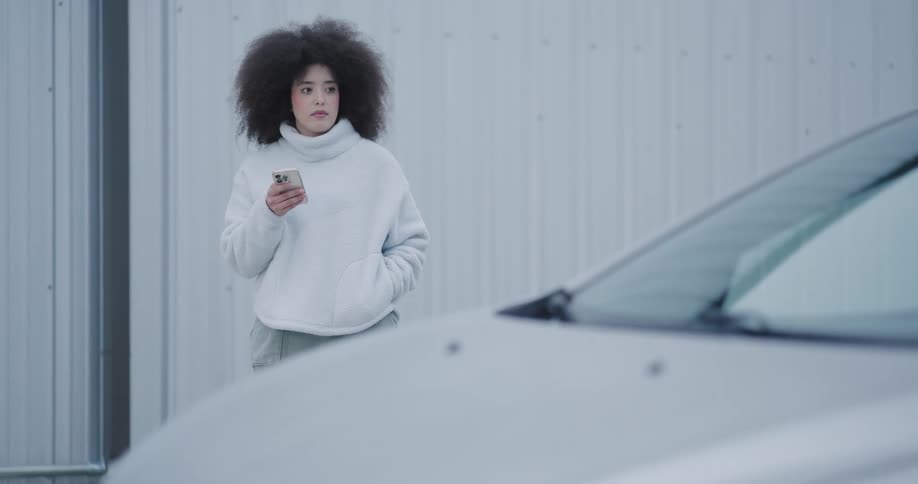 Pedestrian notices car being used for amorous activity and walks away amused and slightly embarrassed