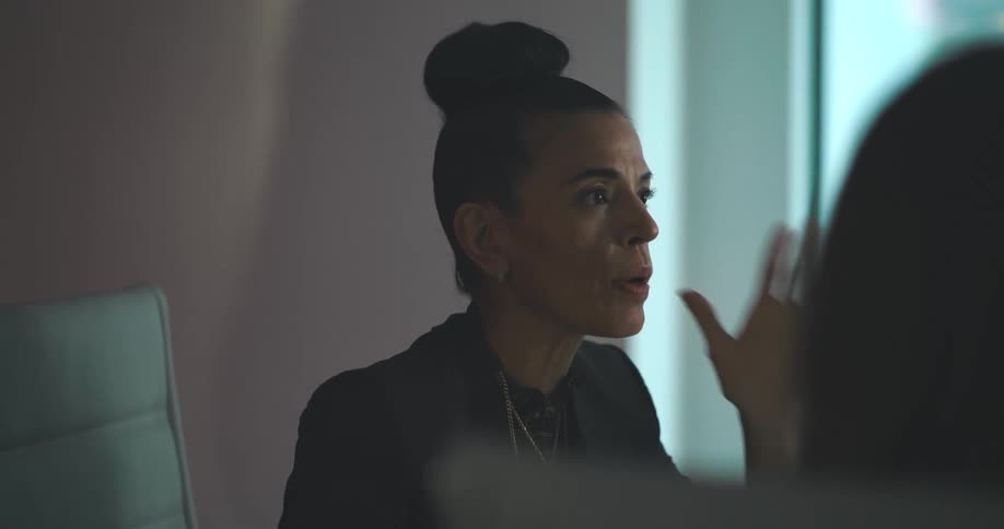 A woman is expressing frustration in an office meeting