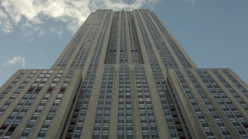 Clouds float over a city skyscraper