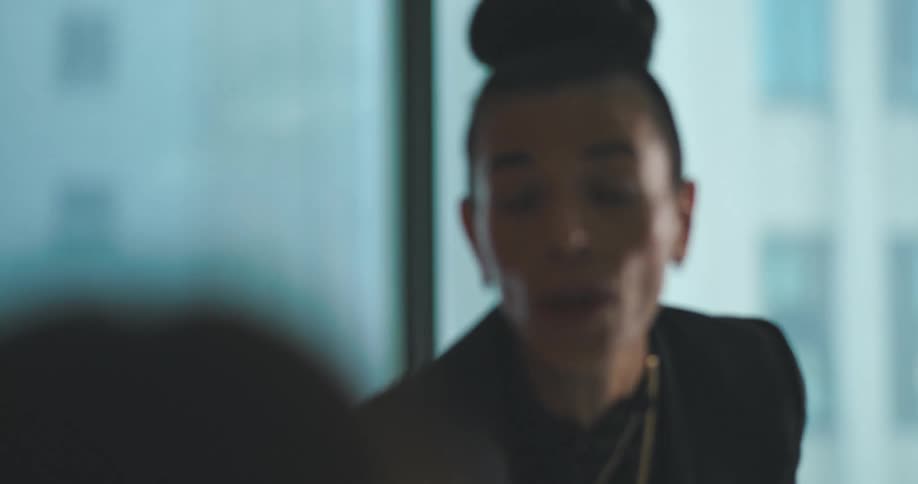 Woman in a meeting room greeting other people