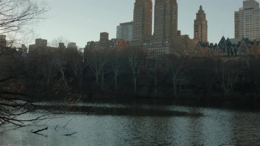 A view of a large city with buildings and a river or waterway in front of them