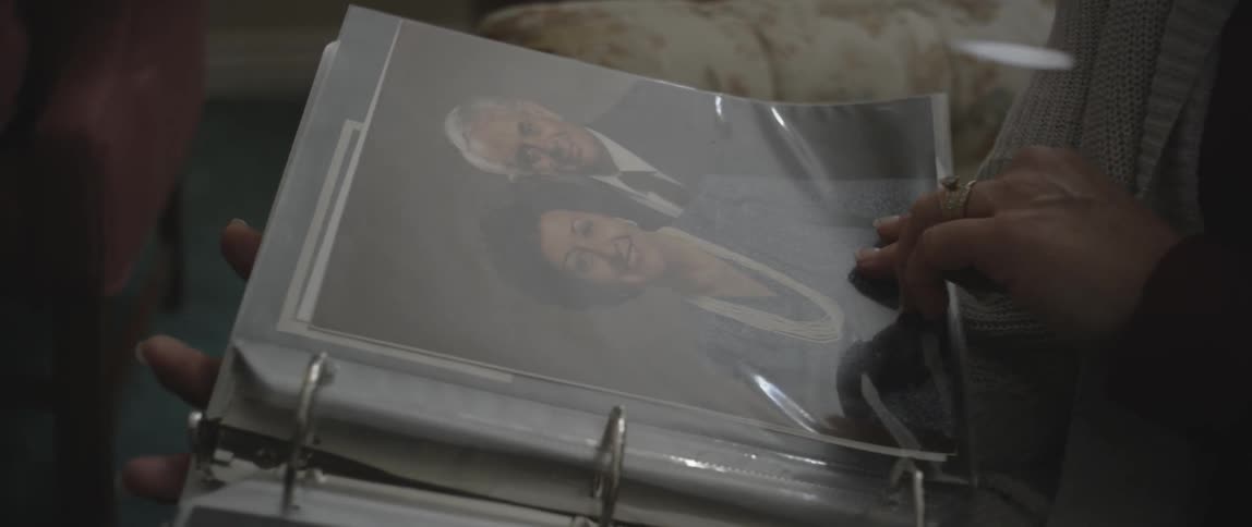 People flip through an album together