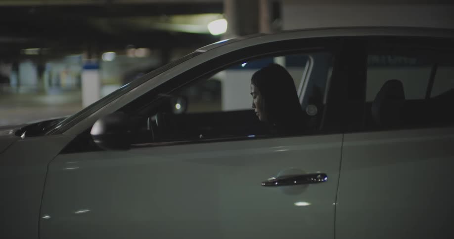 A woman gets out of the car and walks away