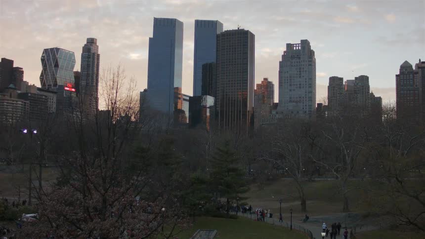 People walking in the city park at sunset
