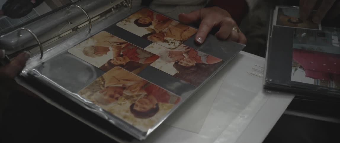 Woman points at a picture in an album