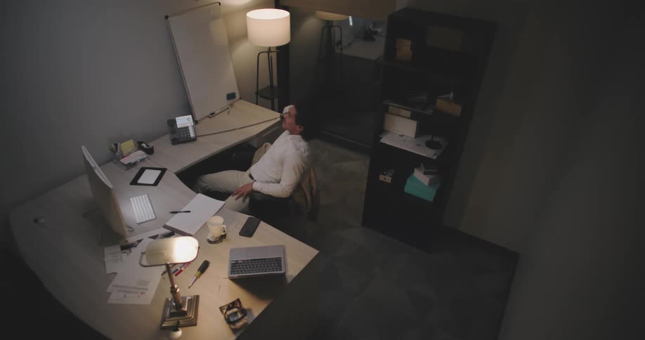 Man answering and ending a phone call while sitting at an office desk