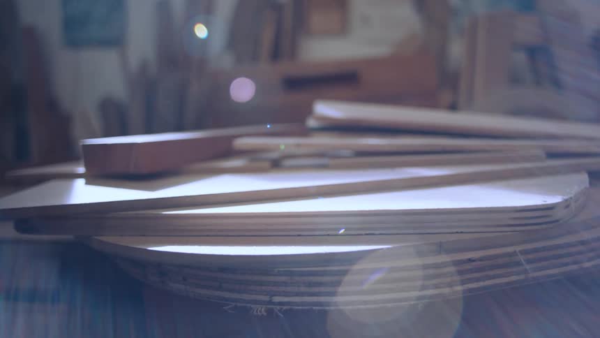 Some flat wooden objects stacked and natural light hitting them