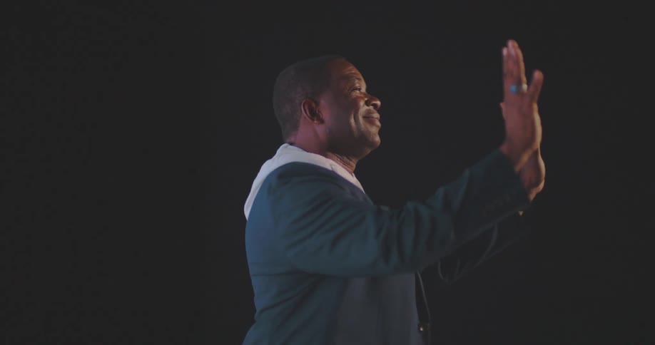 Man entering an auditorium and being flashed with photography