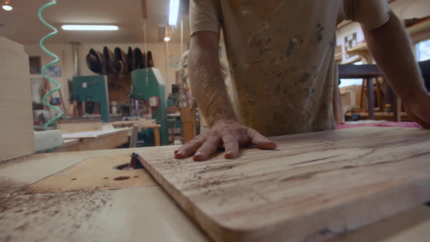 A clip of a carpenter filing a wood
