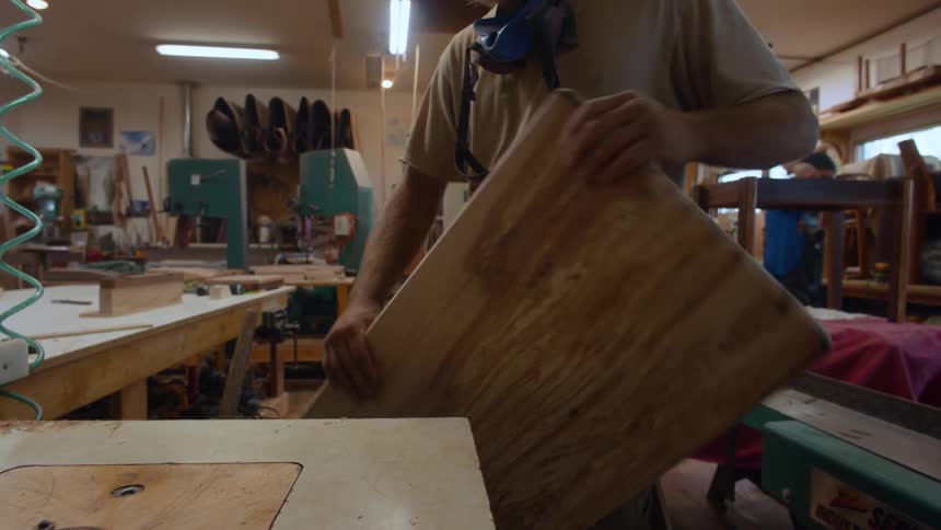 Carpenter man analyzing a piece of wood