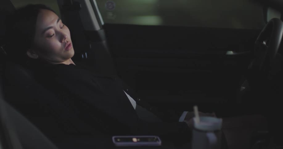 Woman sleeping inside car until she wakes up and quickly leaves