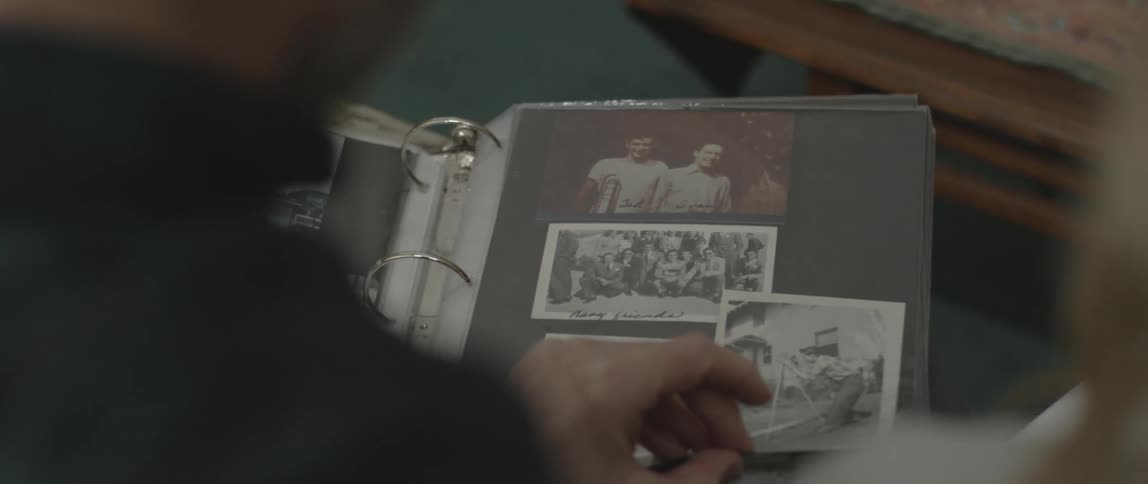A man looks at a photo album