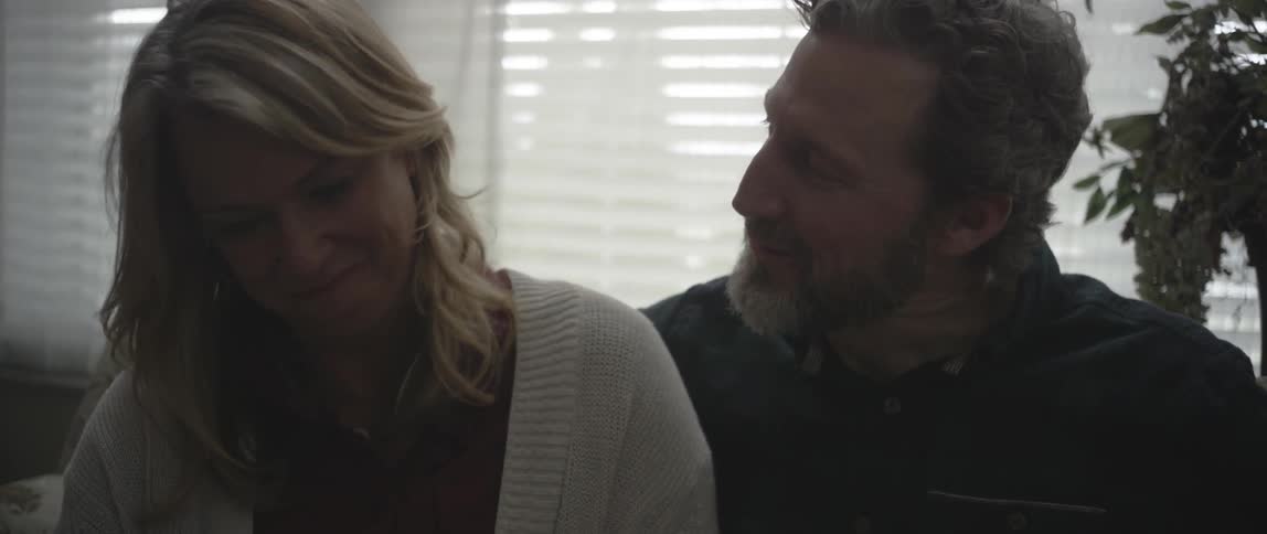 A man and woman sit and talk to each other