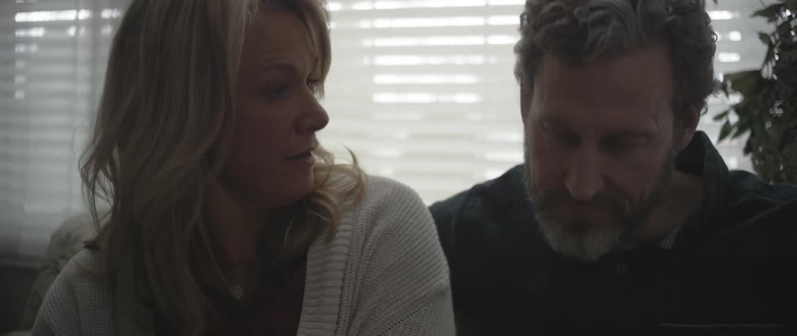 A man and woman sit and talk to each other