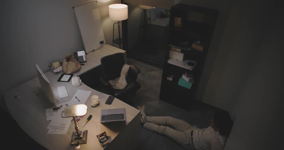 Man walking back and forth in an office room
