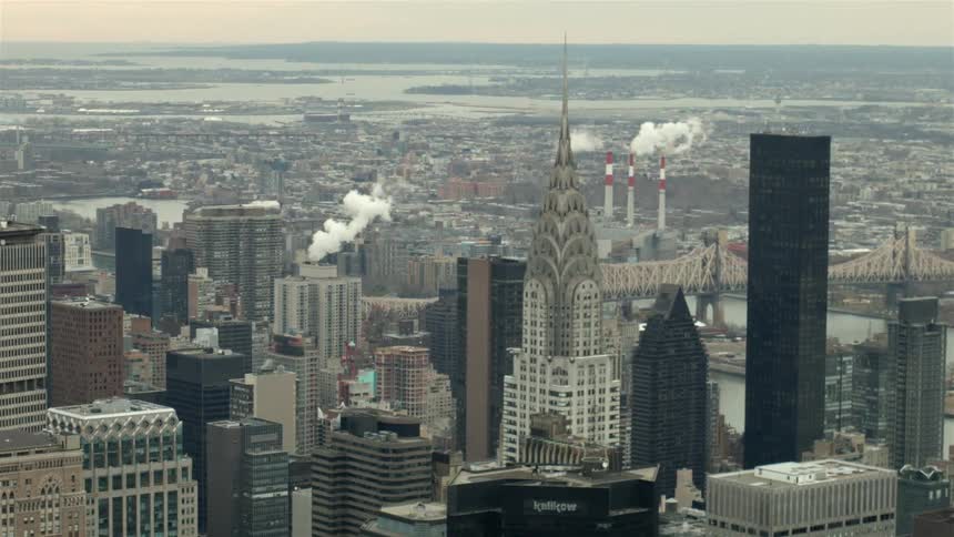 Tall buildings line this city on a cloudy day