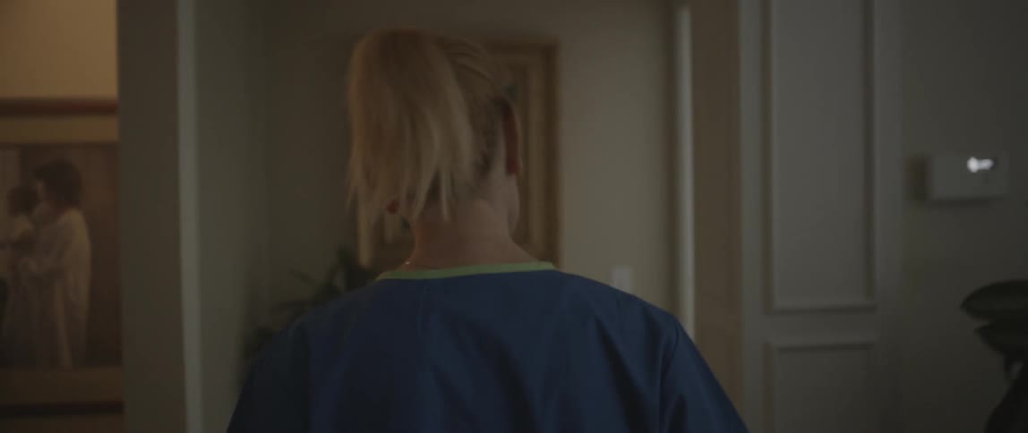 Woman walks down the hallway of a house
