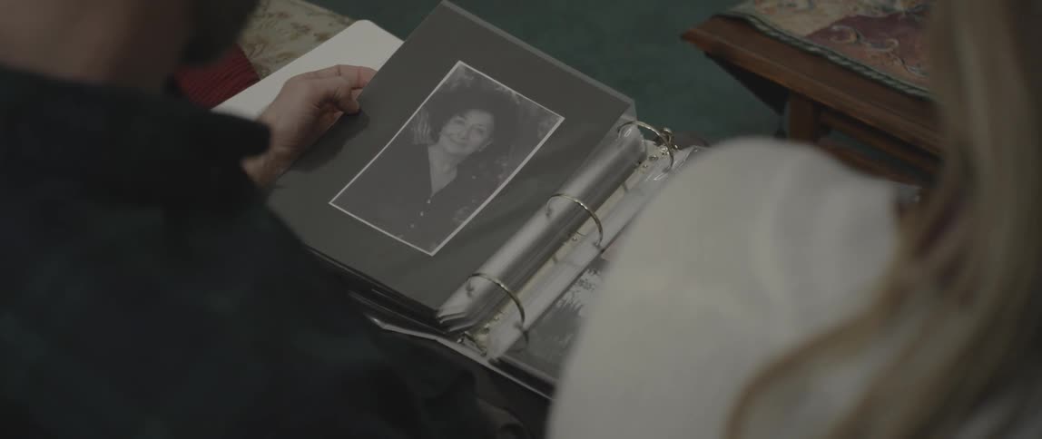 A man is looking through a photo album