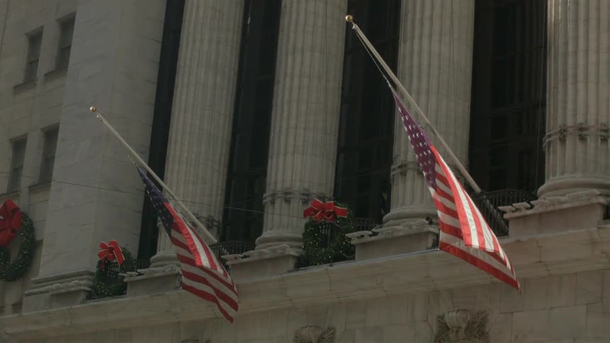View of a building with flags waving outside of it