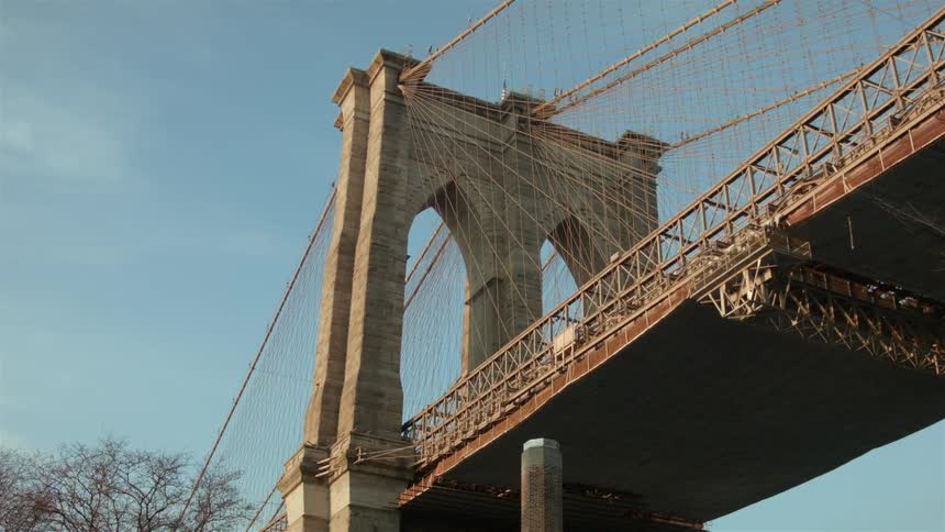 A large bridge fills the sky on a sunny day