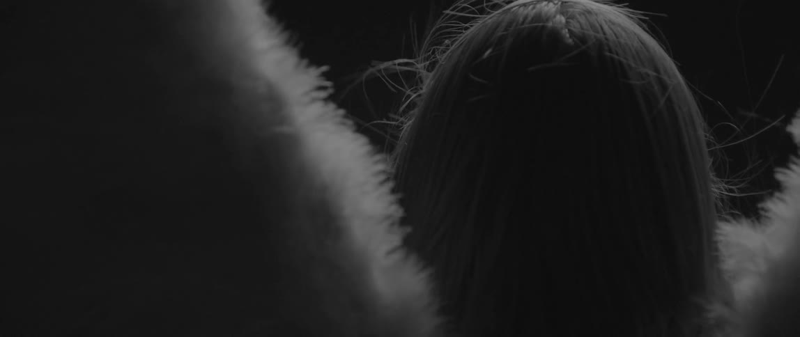 A woman's hair is blowing in the wind