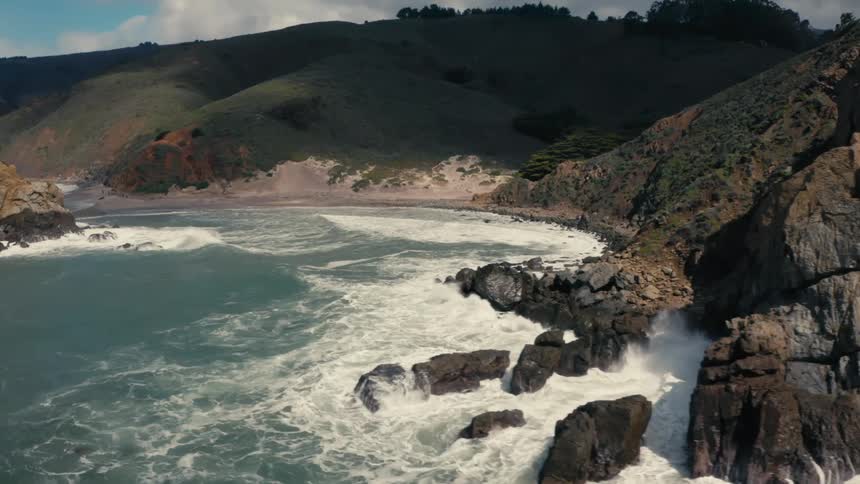 Waves crash against the rocks on the island