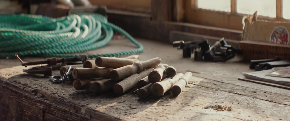 Wooden fishing equipment on the table with marine rope next to it