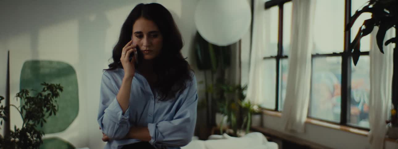 A woman is listening on her cell phone