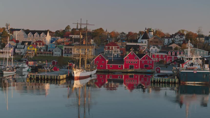 Boats are docked along the harbor in a small fishing village