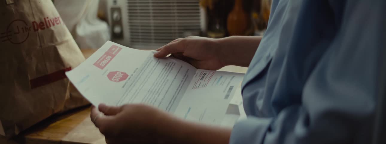 Pair of hands opening a letter