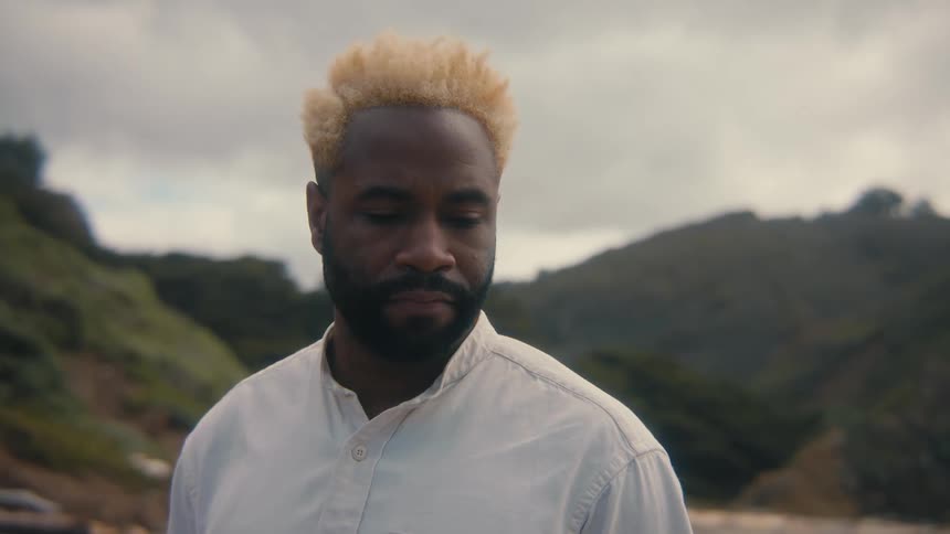 Portrait of a man in a natural environment surrounded by mountains