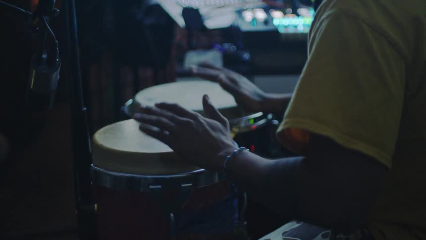 Pair of hands of a man playing drums in a studio