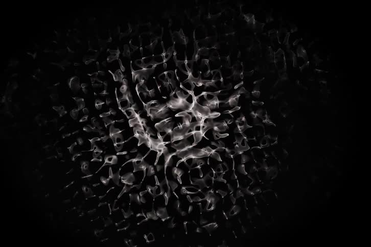 An abstract pattern of white wavy lines and shapes on a black background