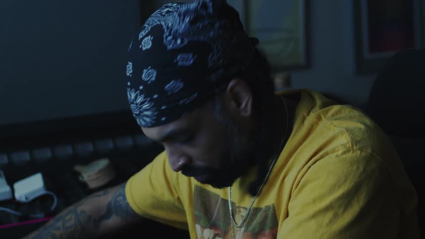 A man is making music in his studio