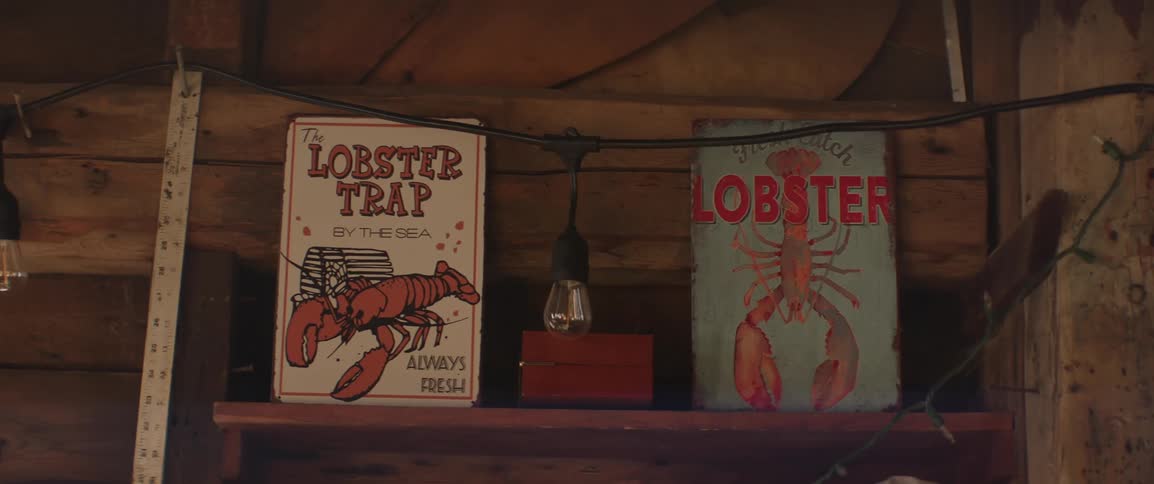 Two small lobster art paintings in a fisherman's workshop