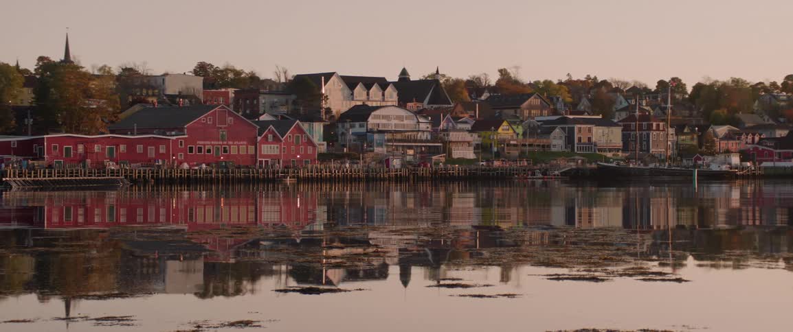 Buildings and houses are part of a harbor town at sunrise