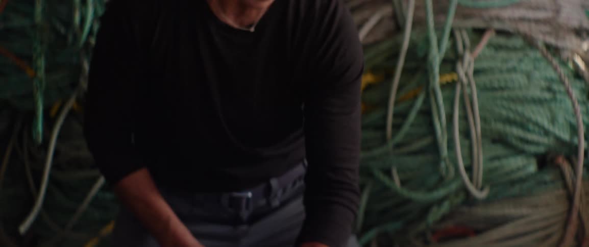 Person in cap winding rope