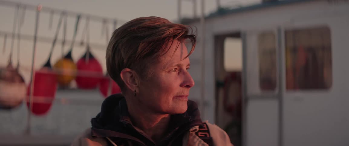 Portrait of a woman smiling on her fishing boat