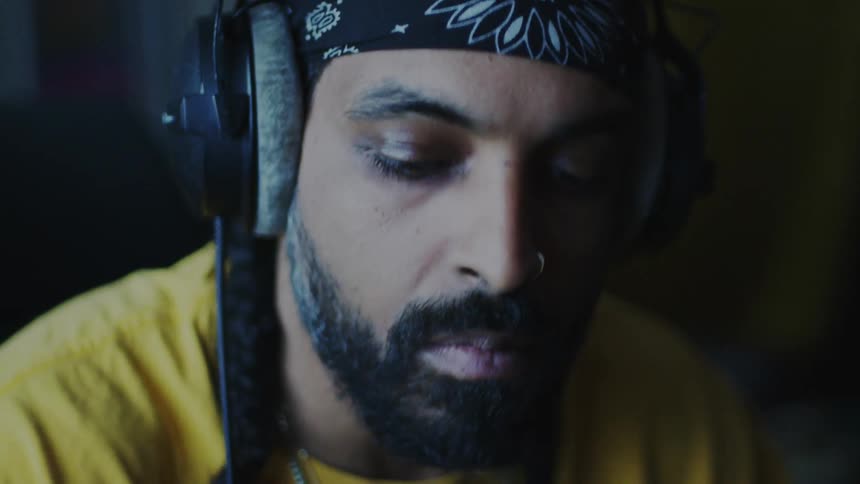 Portrait of a bearded man with bandana and headphones