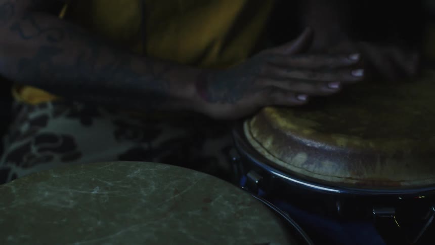 A tight shot of black hands playing drums