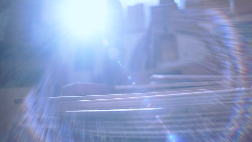 Intense beam of light creating a reflection and distortion effect on a pile of wood