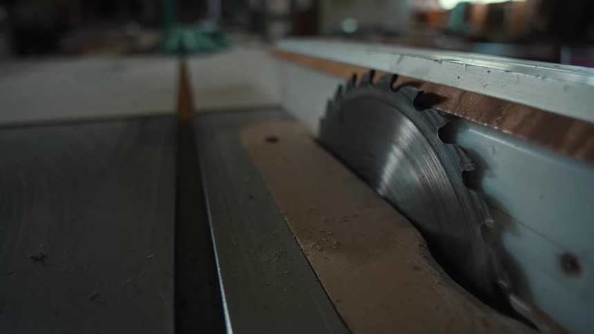 Benchtop circular saw with blade exposed in a carpentry shop
