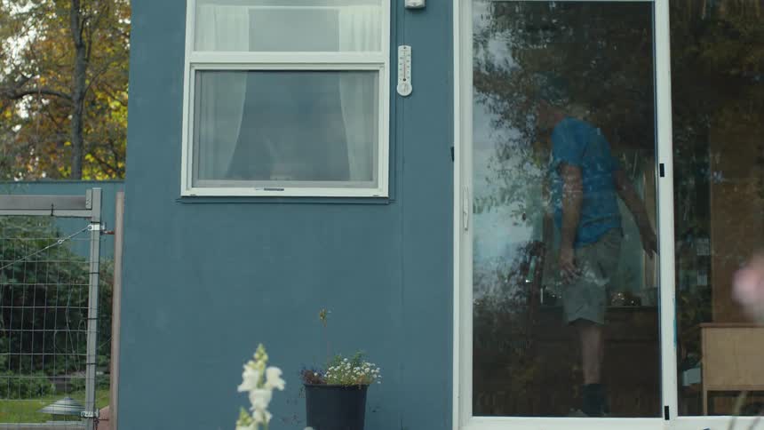 A footage of an elderly man closing the door after