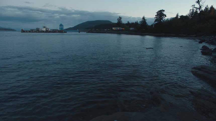 View of a lakeshore near an island at sunset