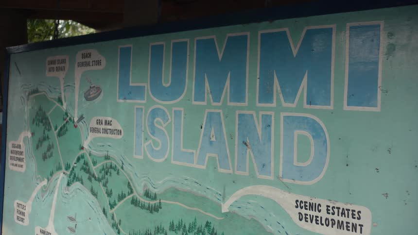 A close up of a detailed map of lummi island displayed on a billboard outdoors